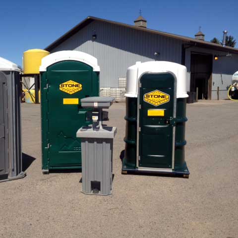 Two different models of portable toilets with a portable sink