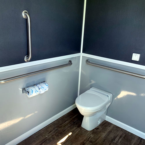 View of ADA toilet with grab bars